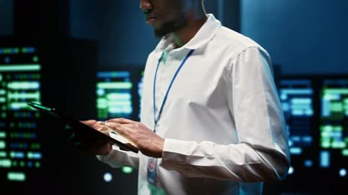 Young Adult Using Tablet in Control Room