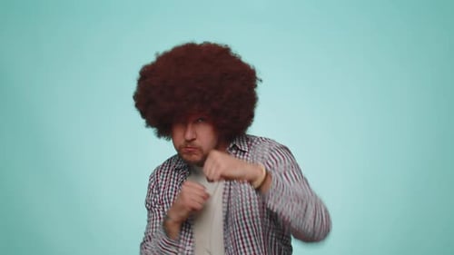 Man Punching at Camera on Blue Background