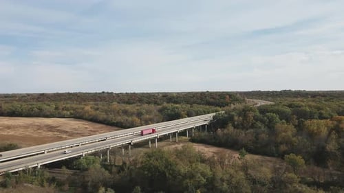 Large red truck moving on road