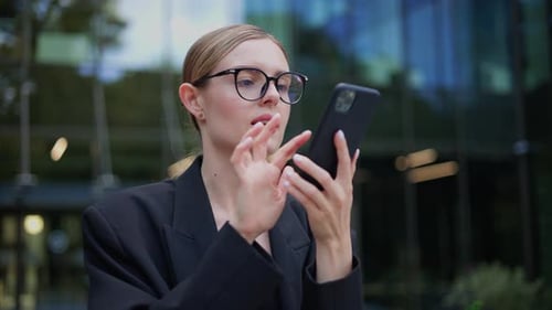 Woman Talking on Smartphone in Urban Setting