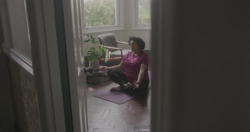 Woman Meditating on Yoga Mat in Sunny Home
