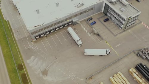 Aerial view. goods distribution warehouse. Semi trucks loading cargo containers. Logistics export an