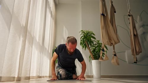 Man Practicing Yoga in a Bright Studio