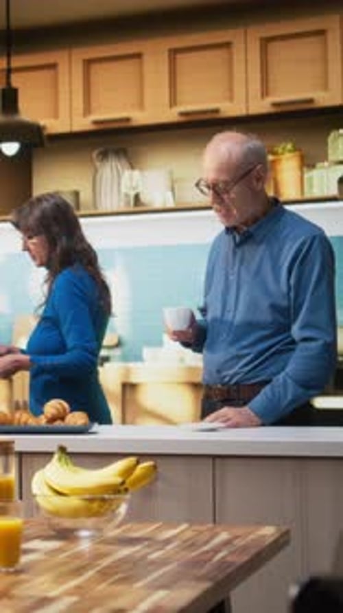 Senior Couple Talking in the Kitchen at Home