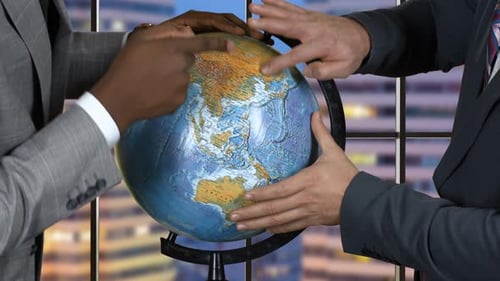 Hands of Men Touch Globe