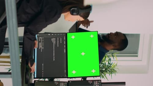 Vertical Video Asian System Engineer Programming App Code on Monitors with Greenscreen