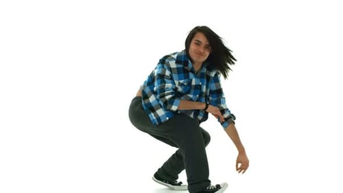 Young male hip hop dancer showing strength and agility in slow motion studio shot