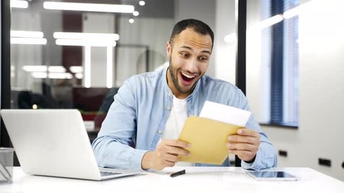 Excited Man Receives Good News at Office Desk