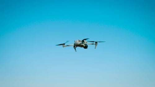 Drone Flying in a Clear Blue Sky