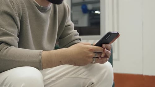 Hands of Unrecognizable Man Typing on Smartphone