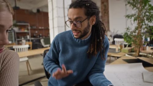 Multiethnic Coworkers Reviewing Architectural Model of Urban Complex in Office