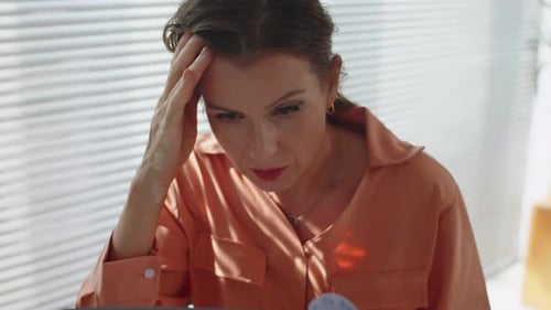 Woman Reading Documents with a Concerned Expression