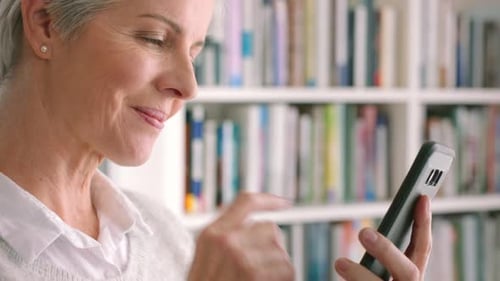 Woman With Gray Hair Uses Smartphone