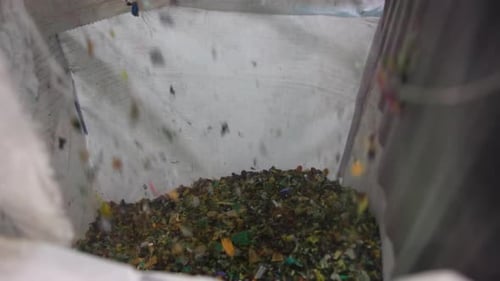 Warehouse Scene Showing Shredded Plastic Being Organized Into Containers For Reuse Process Media