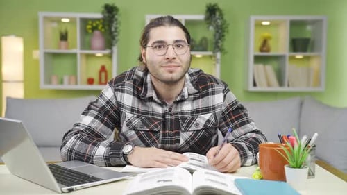 Man Studies at Desk at Home