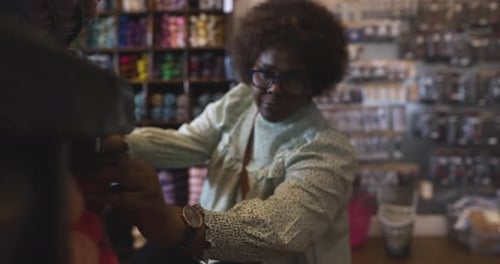 Woman Browsing Shopping for Yarn at Display in Yarn Store 10 Seconds or Greater