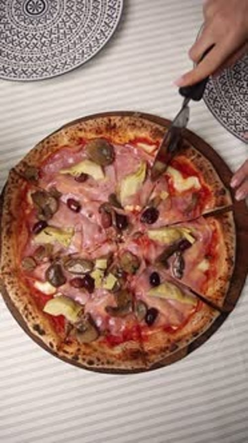 The chef makes delicious pizza in a professional kitchen.