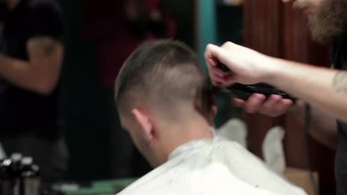 Barber Giving Haircut in Urban Barber Shop