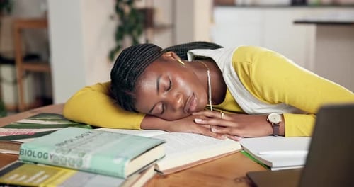 Student Sleeping on an Open Textbook Indoors