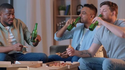 Friendship Food and People Concept - Male Friends Drinking Beer Eating Pizza
