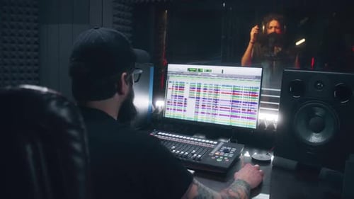 Sound Engineer Records and Create Song for Musician in Recording Studio