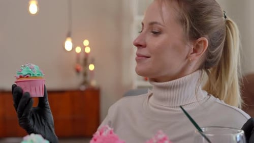 Woman Smiling While Making Cupcakes