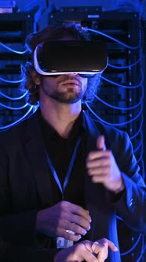 Man using a Virtual Reality headset in a server room. Vertical