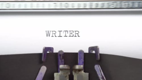 Writer word closeup being typing and centered on a sheet of paper on old vintage typewriter