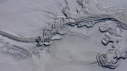 Aerial view of gray abstract mud patterns and cracks on acid mine drainage surface