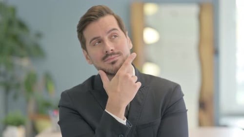 Portrait of Brainstorming Businessman with New Idea