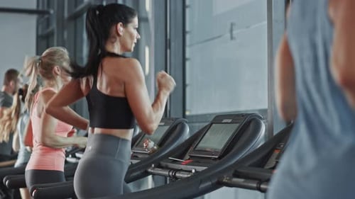Beautiful Athletic Sports Woman Wearing Wireless Headphones, Listens to a Podcast or Sport Music Pl