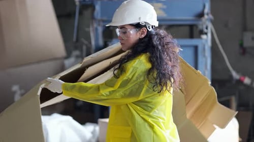 Blackhaired Supervisor Helps Sorting Waste at Factory