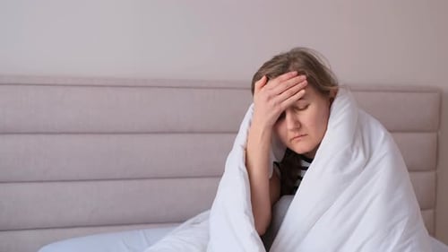 Woman in Bed with Headache, Fatigue