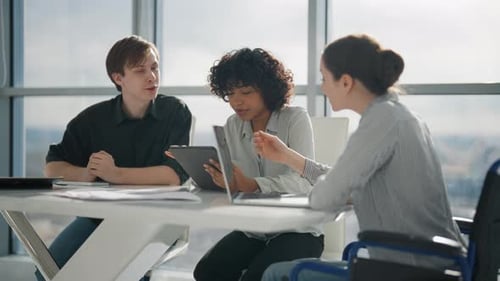 Colleagues Working on Project in Modern Office Together Sitting at Desk Woman in Wheelchair with