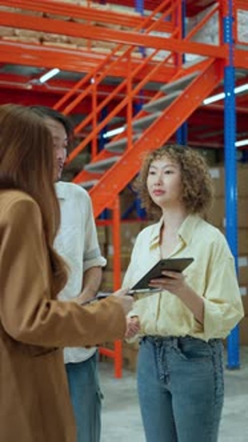 Warehouse team members discussing inventory management