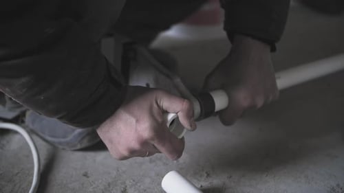 Plumber Soldering Plastic Pipes Closeup