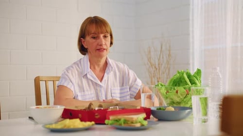 Woman Sitting Alone At Table With Lunch