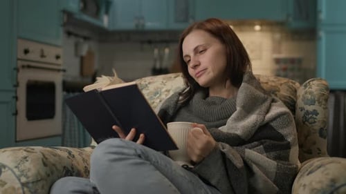 Woman Reading Paper Book at Home