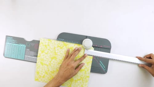 Hands Crafting Yellow Paper Envelope with Pattern