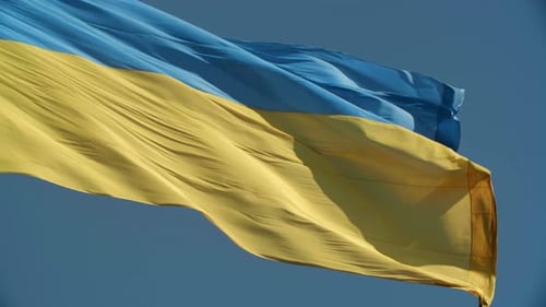 Ukrainian Flag Waving against Blue Sky