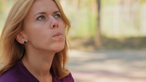 Portrait of Caucasian Pretty Lady Eating Leaf of Green Salad in the Park at Summer Day