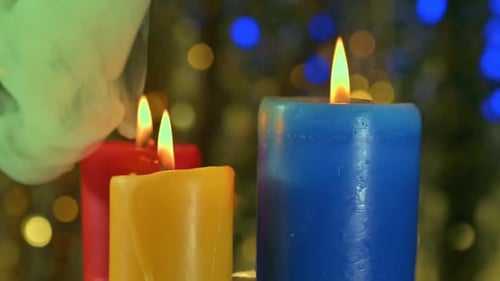Colorful Candles Burning with Flickering Holiday Lights