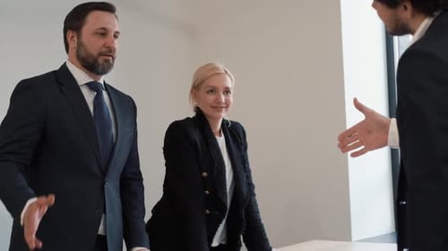 A Man in a Suit a Businessman Shakes Hands with a Colleague Shaking Hands in the Office