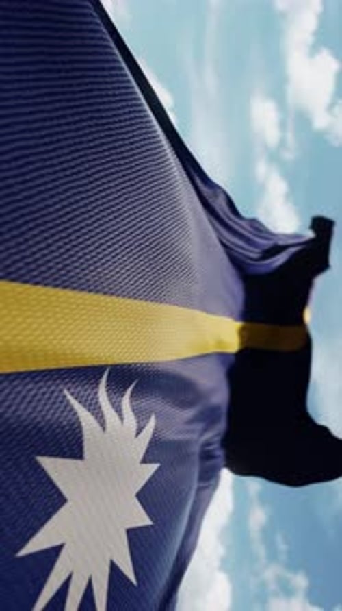 Realistic Nauru Flag Waving Against Blue Sky
