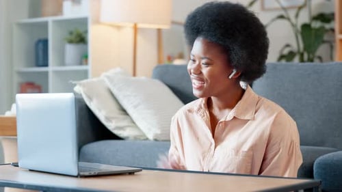 Woman Video Chatting on Laptop at Home