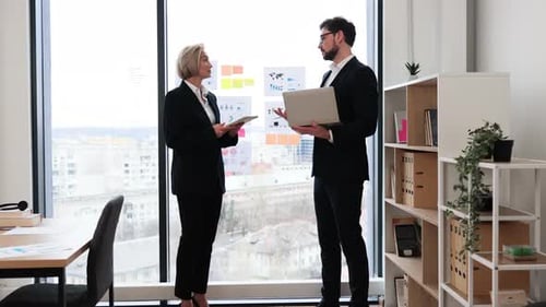 Professional Business Meeting Between Colleagues in a Modern Office Environment