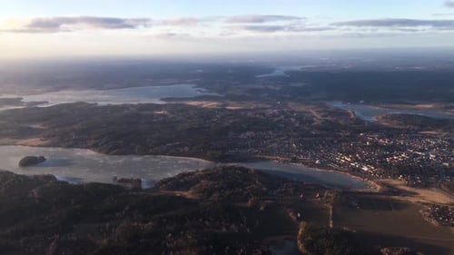view from an airplane flying above frozen lakes