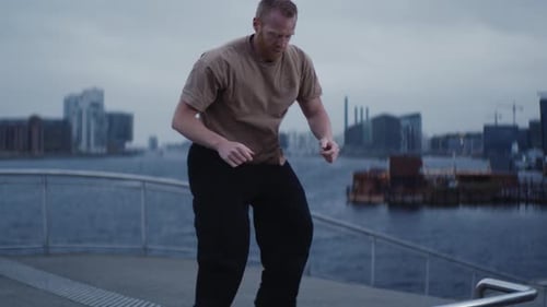 Man Working Out on Urban Waterside Boardwalk