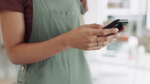Person Using Smartphone in an Office or Retail Setting