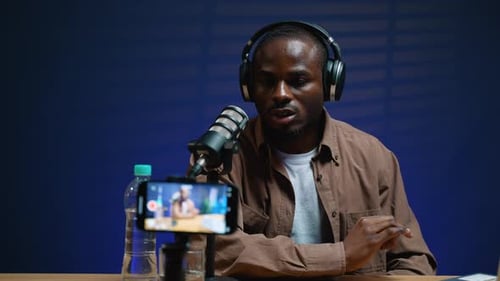 Young Adult Recording Podcast At Table Indoors